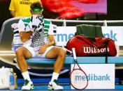 Switzerland's Roger Federer wipes his face with a towel during his semi-final match against Serbia's Novak Djokovic at the Australian Open tennis tournament at Melbourne Park, Australia, January 28, 2016. REUTERS/Thomas Peter