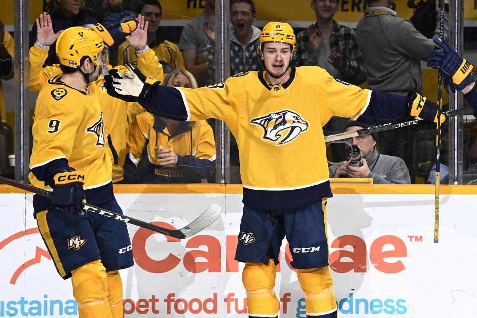 Nashville Predators center Cody Glass (8) celebrates with left wing Filip Forsberg (9) after Glass scored a goal against the Winnipeg Jets during the second period of an NHL hockey game Tuesday, Jan. 24, 2023, in Nashville, Tenn. (AP Photo/Mark Zaleski)