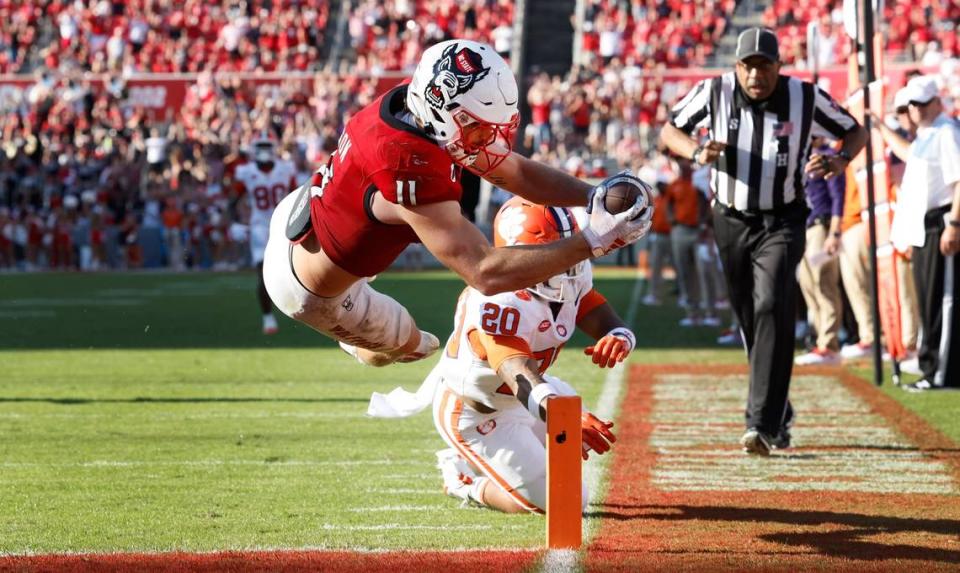 N.C. State’s Payton Wilson (11) dives in to score on a 15-yard touchdown interception during the second half of N.C. State’s 24-17 victory over Clemson at Carter-Finley Stadium in Raleigh, N.C., Saturday, Oct. 28, 2023.