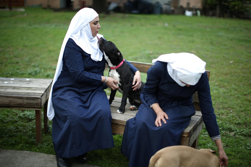 California "weed nun" Desiree Calderon, who goes by the name Sister Freya (L), and India Delgado, who goes by the name Sister Eevee, sit with their pets in the garden at Sisters of the Valley near Merced, California, U.S., April 18, 2017. Picture taken April 18, 2017. REUTERS/Lucy Nicholson