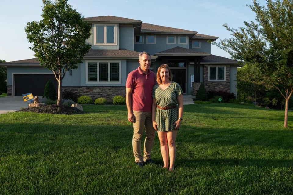 Andreas and Becca Stabno outside their 6,000-square-foot Lee’s Summit home. A 30-foot fire pole, Hogwarts room, Narnia secret wardrobe and Lego room sit inside.