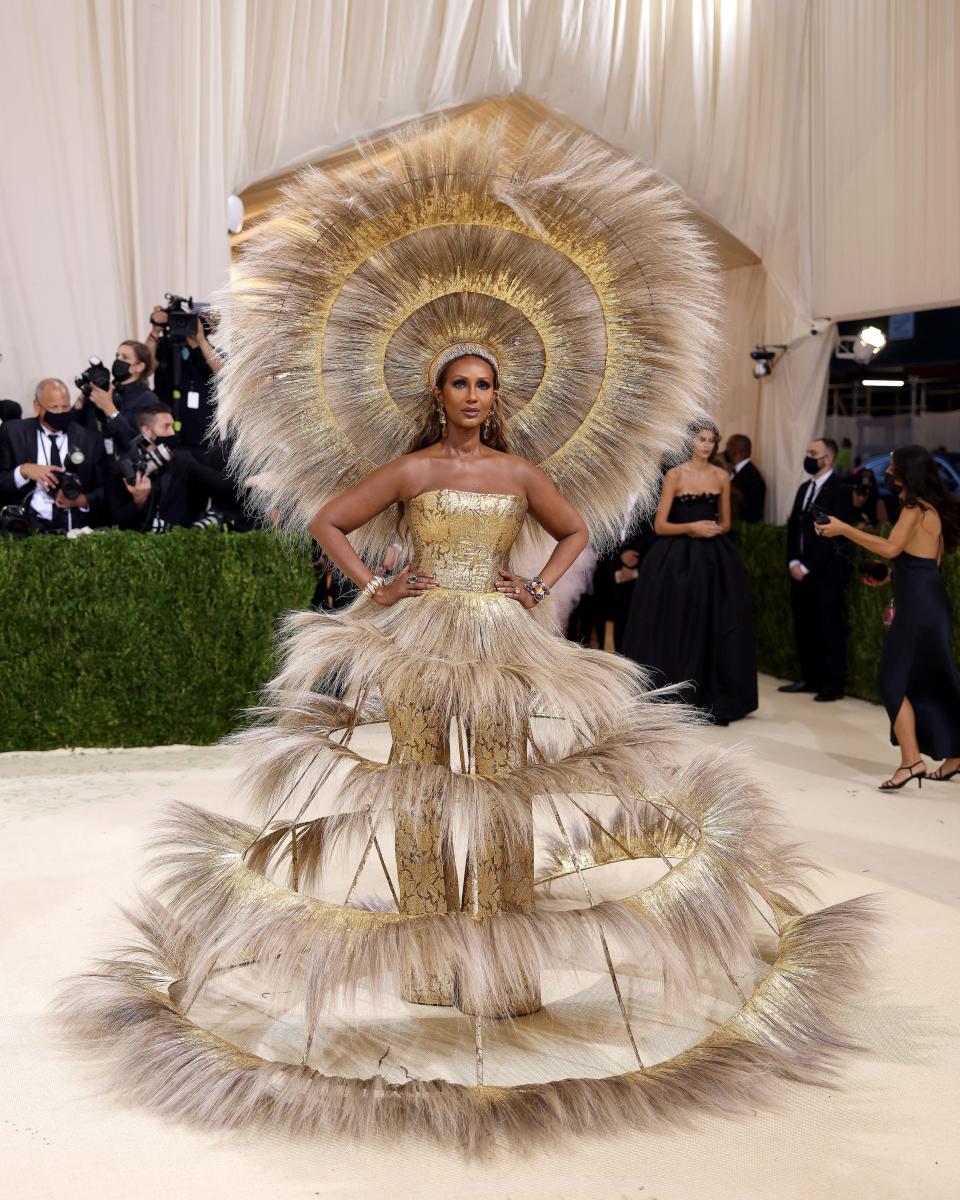 Iman wears a tiered dress and matching headpiece at the Met Gala.