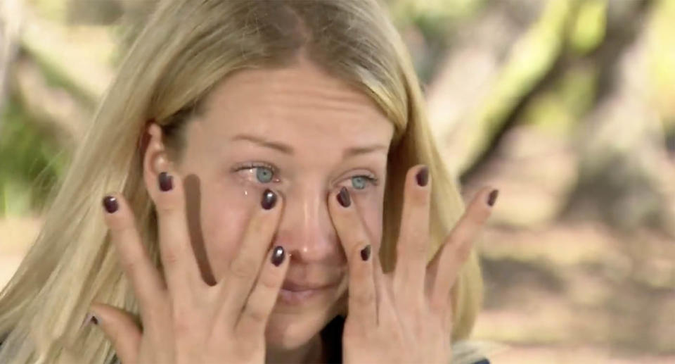 International student Riina Haapala wipes away her tears while talking to 9News about her damaged car.