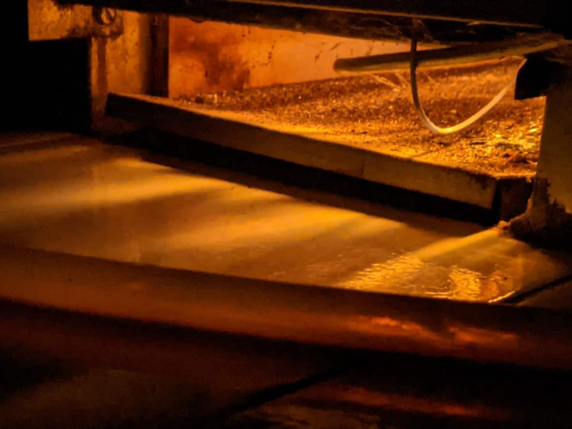 The warm glow of a gas furnace in a Toronto home, one of millions across Canada using what has been a cheap fuel, even if it contributes greenhouse gasses. Now prices are rising, and those who watch energy markets say that's likely to continue. (Don Pittis/CBC - image credit)