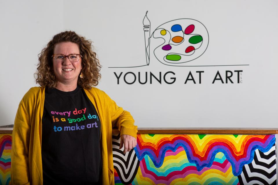 Karla Young, owner of Young at Art art studio, stands inside of her studio on Chestnut Street in Lancaster, Ohio on December 3, 2021.