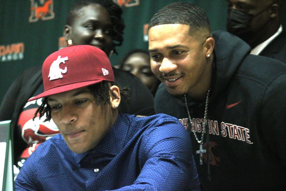 Surrounded by teammates and family, Mandarin safety Tony Carter signs a national letter of intent to play college football at Washington State University during National Signing Day, February 2, 2022. [Clayton Freeman/Florida Times-Union]