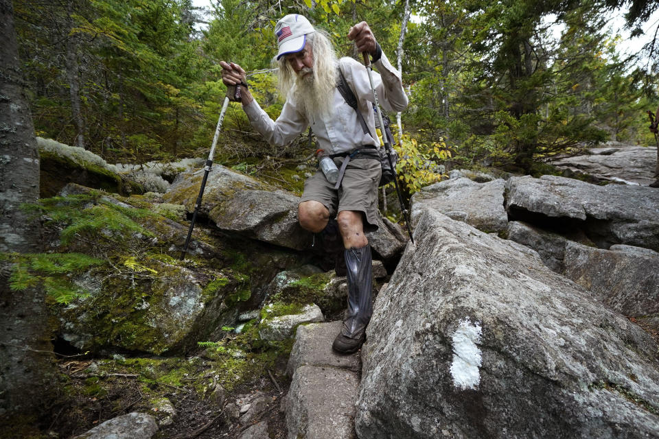 M.J. Eberhart, 83, carefully makes his way through large rocks while descending Mount Hayes on the Appalachian Trail, Sunday, Sept. 12, 2021, in Gorham, New Hampshire. Eberhart, who goes by the trail name of Nimblewill Nomad, is the oldest person to hike the entire 2,193-mile Appalachian Trail. (AP Photo/Robert F. Bukaty)