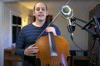 This Oct. 5, 2020, still image from video provided by Mike Block shows Block at his home in Somerville, Mass. The cellist organized "Play for the Vote," a nationwide, nonpartisan effort being produced by the Boston-based music collective Silkroad to get fellow musicians to serenade voters at polling places through Election Day. In the best of times, it’s a massive logistical challenge to get millions out to vote. In 2020, the difficulty has been dramatically compounded: by fear of the coronavirus, by complications and confusion over mail-in ballots, by palpable anxiety over the bitter divisions in the country. (Mike Block via AP)
