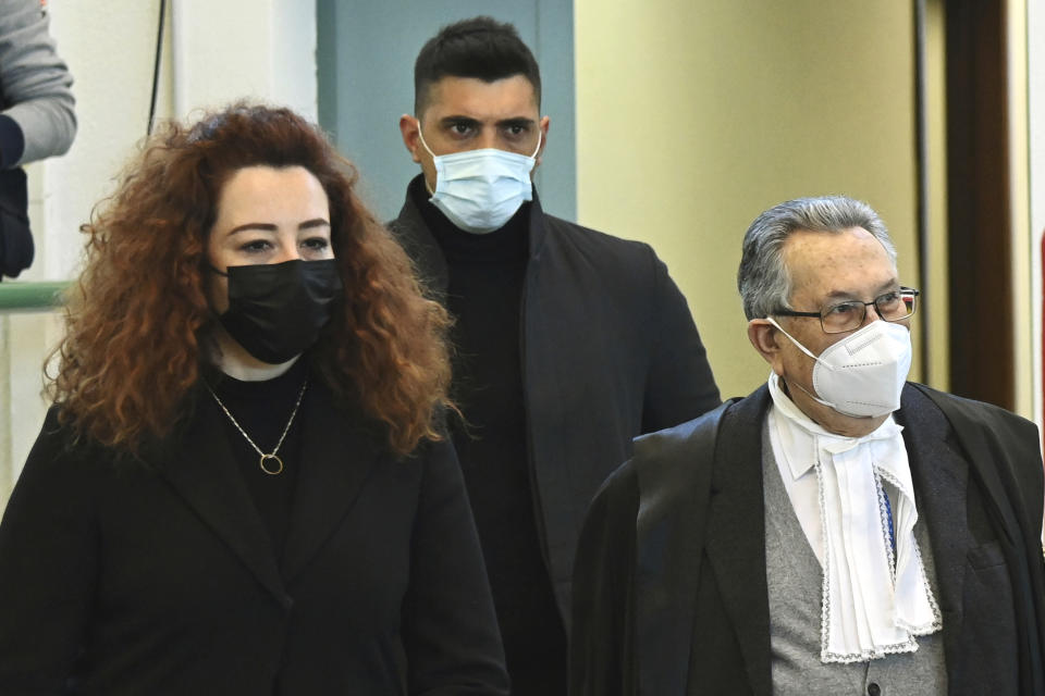 Rosa Maria Esilio, left, widow of slain Carabinieri military police officer Mario Cerciello Rega, followed by Paolo Cerciello Rega, brother of Mario, arrives with their lawyer Franco Coppi for a hearing in the trial where two American tourists are accused of slaying the plainclothes Carabinieri officer while on vacation in Italy in July 2019, in Rome, Monday, March 1, 2021. (Alberto Pizzoli/Pool Photo via AP)