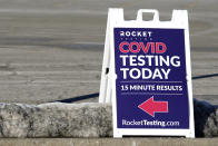 A COVID-19 testing site sign is seen at the Hawthorn Mall parking lot in Vernon Hills, Ill., Thursday, Jan. 21, 2021. A new drive-up rapid COVID-19 testing facility has opened in Vernon Hills. Rocket Testing, which currently has seven locations in the Chicago area. (AP Photo/Nam Y. Huh)