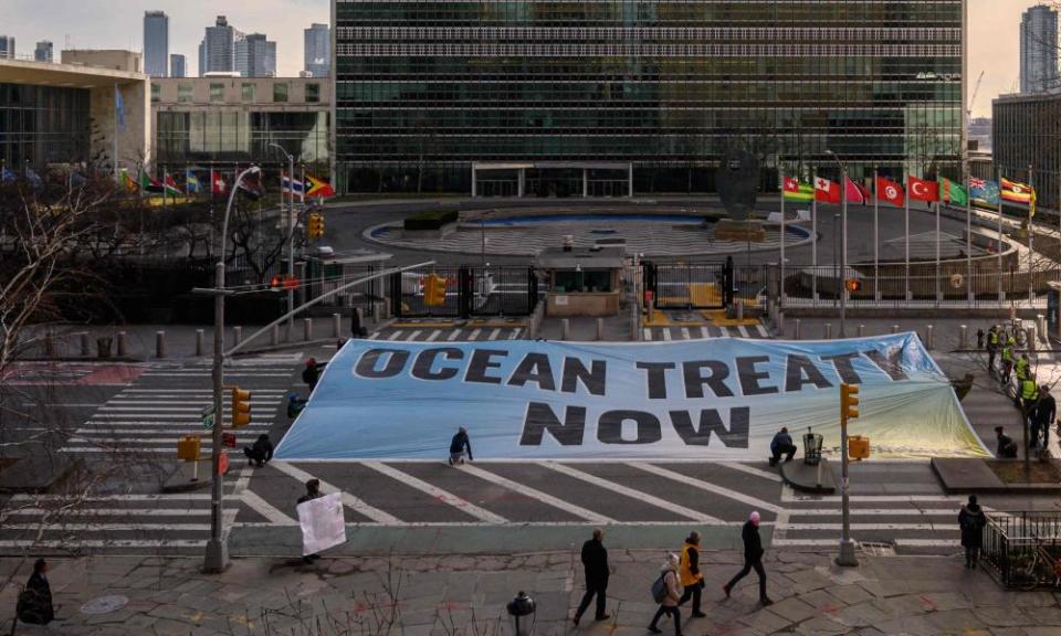 Activists from Greenpeace unfurl banner