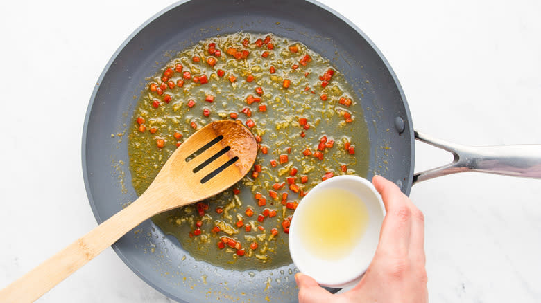 adding lemon juice to frying pan