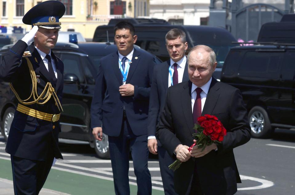 Russian President Vladimir Putin takes part in a flower-laying ceremony at a monument to Soviet soldiers, who died in battles for the liberation of China, in Harbin, China (via REUTERS)