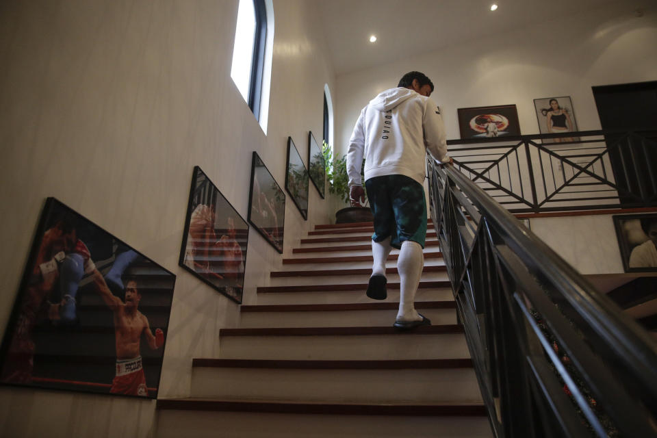 FILE - In this Jan. 14, 2019, file photo, boxer Manny Pacquiao walks up the steps to his bedroom for a nap following his morning run in Los Angeles. A spokesman for Pacquiao says the famed fighter's Los Angeles home was robbed at about the time he was in the ring with rival Adrien Broner in Las Vegas. Spokesman Mike Quinn confirmed the burglary to NBC News. Los Angeles police said a burglary was reported about 4:15 p.m. Sunday, Jan. 20, 2019. in the Larchmont neighborhood. (AP Photo/Jae C. Hong, File, File)