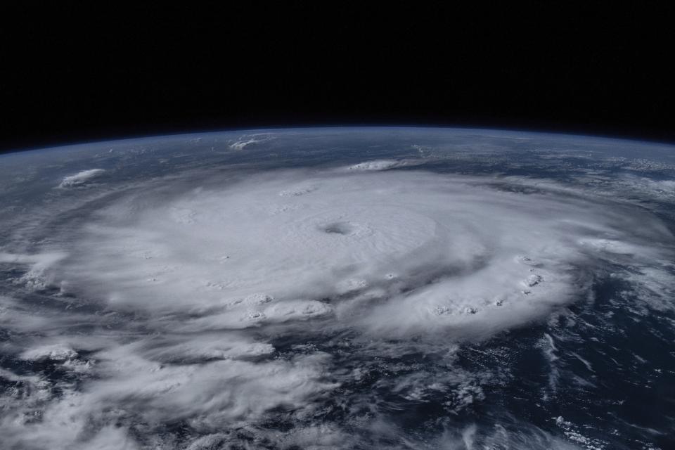 Image from expanse of Earth with large spiraling darken structure.