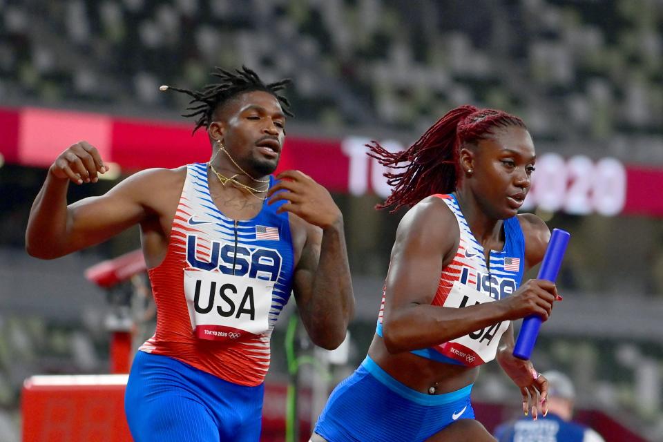 USA's Elija Godwin (L) and Lynna Irby compete in the mixed 4x400m relay heats during the Tokyo 2020 Olympic Games at the Olympic Stadium in Tokyo on July 30, 2021. (Photo by Javier SORIANO / AFP) (Photo by JAVIER SORIANO/AFP via Getty Images)