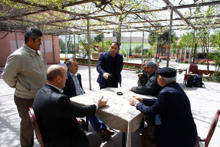 Oktay Teke, mukhtar of Sazlibosna, chats with villagers at a teahouse in Sazlibosna in Istanbul, Turkey, April 16, 2018. REUTERS/Osman Orsal