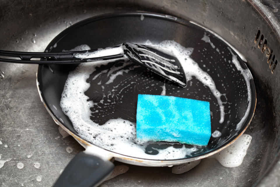 to wash the dirty dishes in the sink in the kitchen