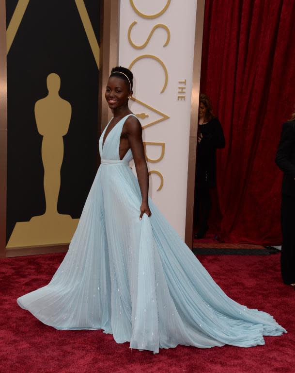 Winner for Best Supporting Actress in "12 Years a Slave" Lupita Nyong'o arrives on the red carpet for the 86th Academy Awards on March 2, 2014 in Hollywood, California