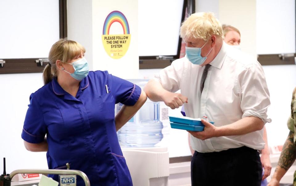 Prime Minister Boris Johnson greets a member of staff during a visit to a vaccination centre in in Moulton Park, Northampton (Peter Cziborra/Reuters/Pool/PA) (PA Wire)