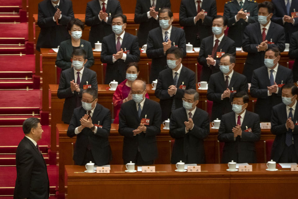 Delegates applaud as Chinese President Xi Jinping arrives for a session of China's National People's Congress (NPC) at the Great Hall of the People in Beijing, Friday, March 10, 2023. Chinese leader Xi Jinping was awarded a third five-year term as president Friday, putting him on track to stay in power for life at a time of severe economic challenges and rising tensions with the U.S. and others. (AP Photo/Mark Schiefelbein)