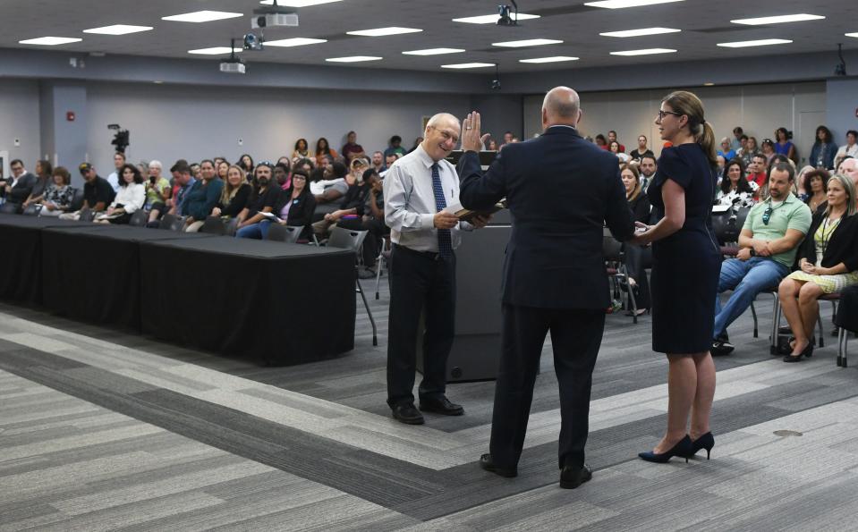 The May 30 meeting of the Brevard County School Board in Viera included the swearing-in ceremony for the new Brevard Public Schools superintendent, Mark Rendell. With him is his wife, Heidi, and performing the swearing in is Pastor Ron Meyr of Faith Viera Lutheran Church.