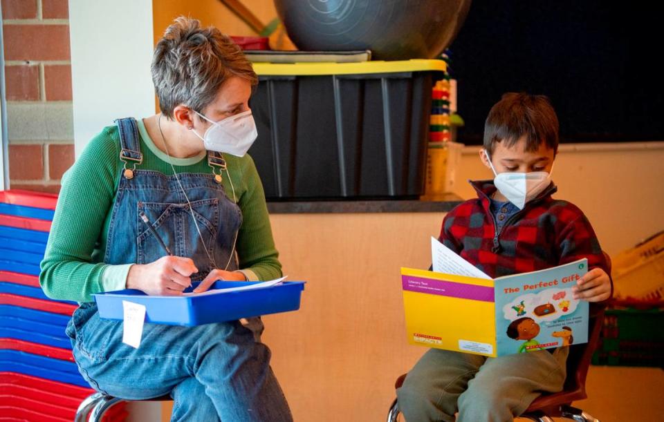 Marcie Rockey listens to one of her kindergarten students read a book at Mount Nittany Elementary on Friday.