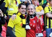 A Borussia Dortmund fan (left) and Bayern Munich fan (right) in the stands before kick-off