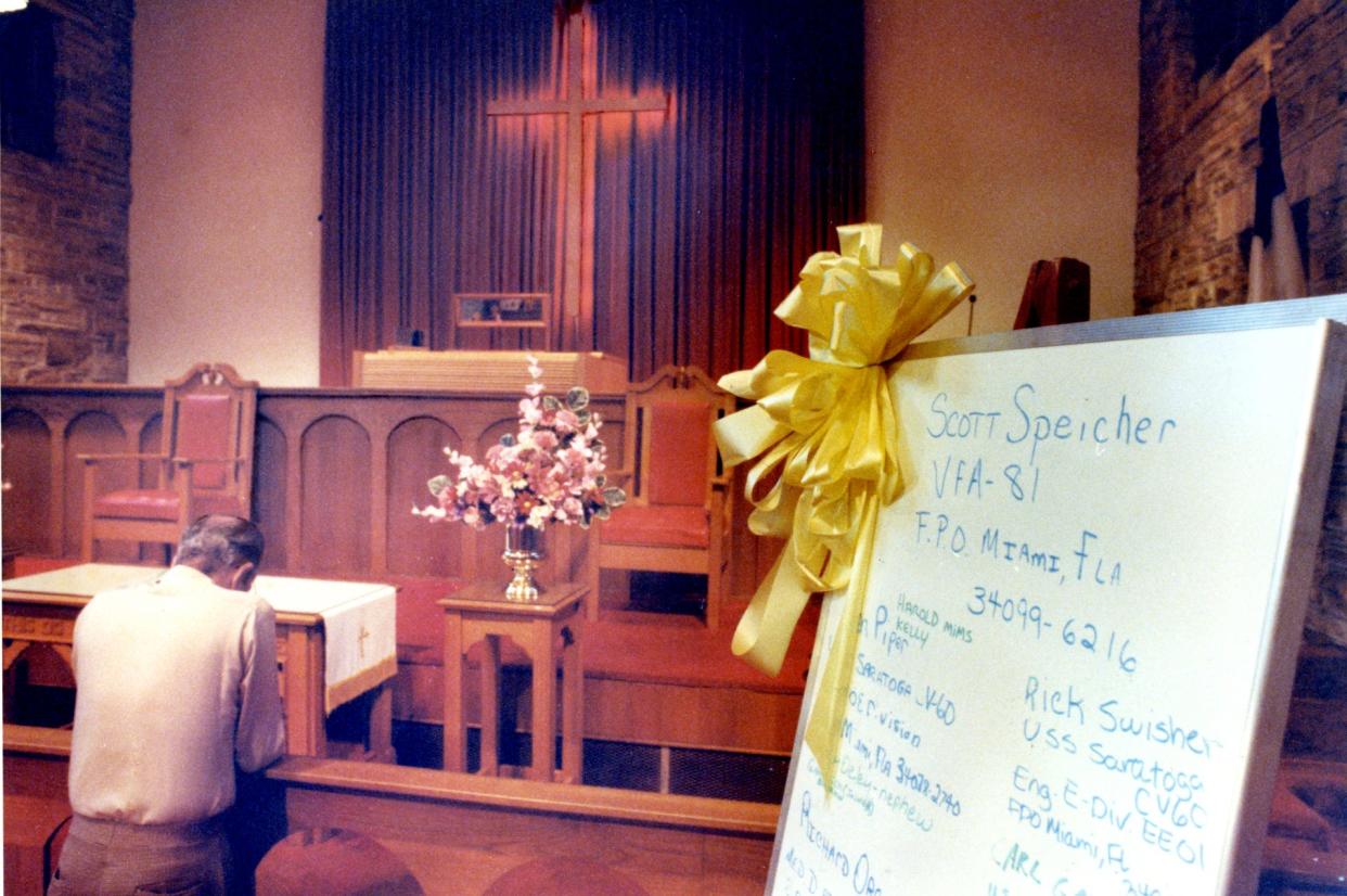 A man prays inside Lake Shore United Methodist Church durnig a vigil for military members involved in the 1991 Persian Gulf war.