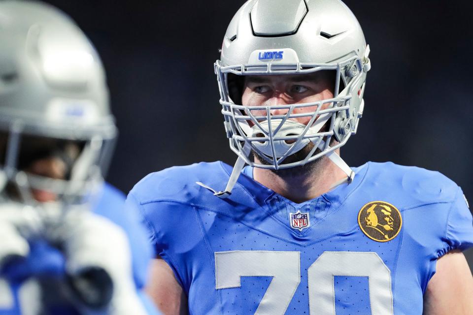 Detroit Lions offensive tackle Dan Skipper warms up before the game against the Green Bay Packers at Ford Field in Detroit on Thursday, Nov. 23, 2023. A patch featuring John Madden is seen in tribute to the Hall of Fame coach and broadcaster.