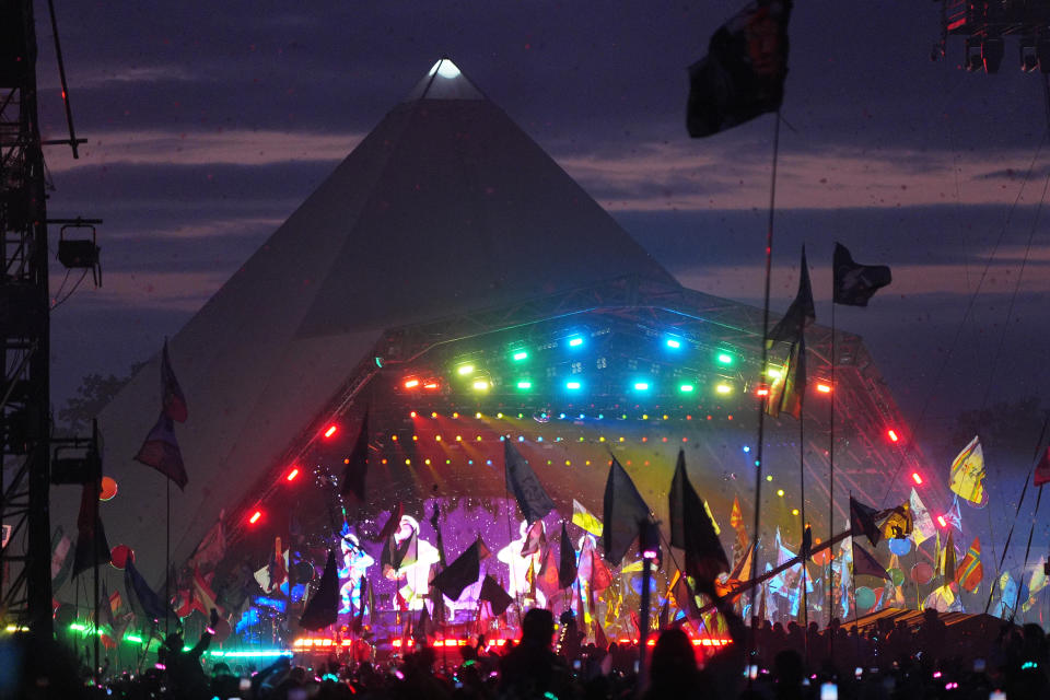 The crowd watching Coldplay performing on the Pyramid Stage at Glastonbury Festival 2024