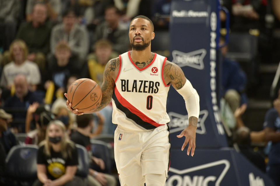 Portland Trail Blazers guard Damian Lillard (0) brings the ball up court in the first half of an NBA basketball game against the Memphis Grizzlies Sunday, Dec. 19, 2021, in Memphis, Tenn. (AP Photo/Brandon Dill)