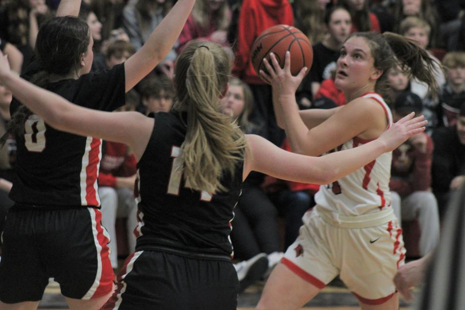 Onaway junior guard Kailyn George (right) gets ready to put up a shot during the first half against Bellaire on Friday. George led the Cardinals with a game-high 24 points.