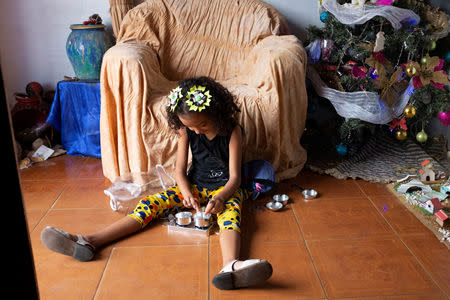 Anthonella Peralta plays at the home of her grandmother Aura Orozco in the slum Cota 905 in Caracas, Venezuela December 18, 2018. Picture taken December 18, 2018. REUTERS/Marco Bello