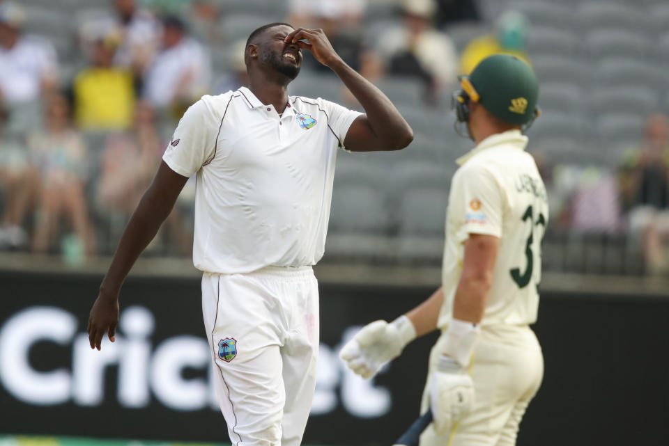 West Indies' Jason Holder bowler reacts to Australia's Marnus Labuschagne during play on the first day of the first cricket test between Australia and the West Indies in Perth, Australia, Wednesday, Nov. 30, 2022. (AP Photo/Gary Day)