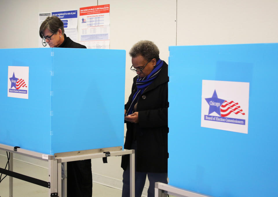 In this Saturday, March 14, 2020 photo, Chicago Mayor Lori Lightfoot casts her ballot during early voting in Chicago. The Illinois state primary elections are scheduled for Tuesday, March 17. (AP Photo/ Noreen Nasir)