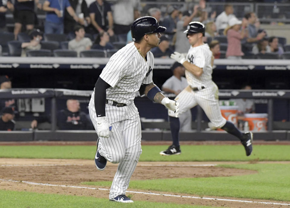 New York Yankees' Gleyber Torres, foreground, runs to first with a two-RBI single as Brett Gardner, right, scores during the eighth inning of a baseball game against the Detroit Tigers Friday, Aug. 31, 2018, at Yankee Stadium in New York. (AP Photo/Bill Kostroun)