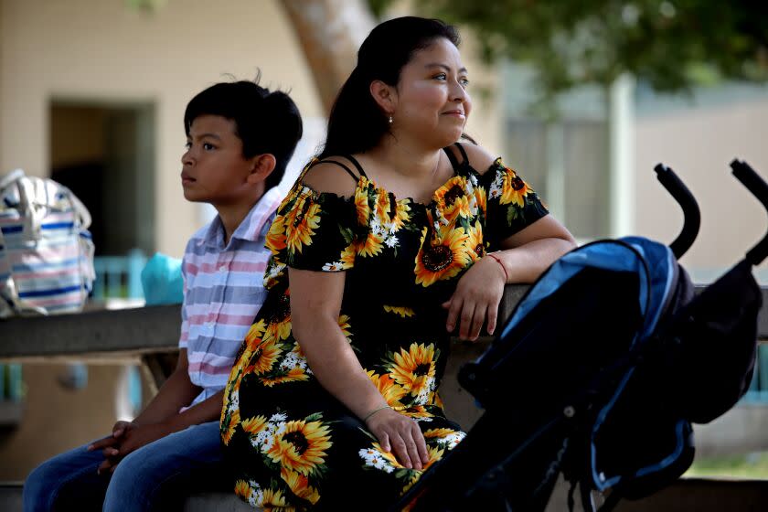 LOS ANGELES, CA - AUGUST 01: Lucrecia (cq) Puac (cq), 34, an immigrant from Guatemala who crossed the Rio Grande to make it to Los Angeles, shown with her son Anderson Molina, 11, at Ruben Salazar park on Monday, Aug. 1, 2022 in Los Angeles, CA. Puac was ordered deported and her case was recently dismissed as she was deemed not a priority for deportation. She is focusing on working to give her young son, Anderson Molina, 11, a better life. (Gary Coronado / Los Angeles Times)