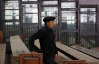 A policeman looks on in front of empty bars during the trial of Muslim brotherhood leaders in Cairo, April 11, 2015. REUTERS/Amr Abdallah Dalsh