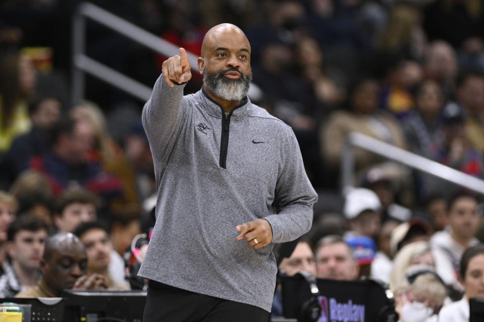 Washington Wizards coach Wes Unseld Jr. points during the first half of the team's NBA basketball game against the Phoenix Suns, Wednesday, Dec. 28, 2022, in Washington. (AP Photo/Nick Wass)