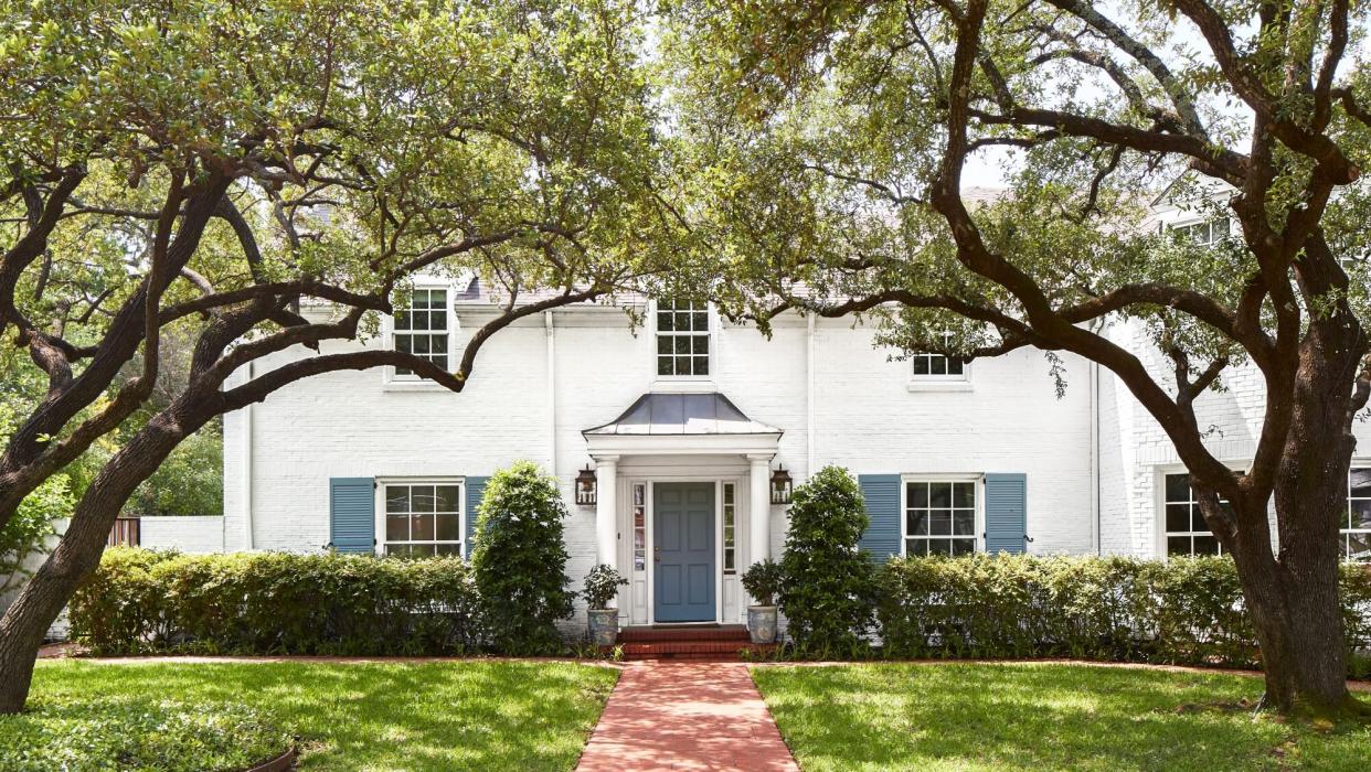 Amy Berry Designed Dallas Home with White Exterior with Blue Shutters