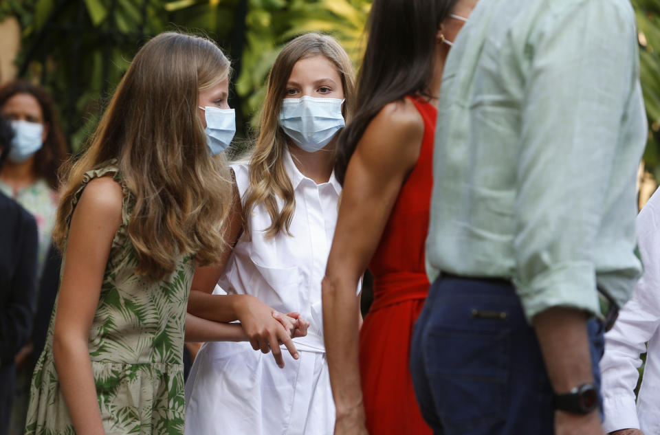 Spain's King Felipe and Queen Letizia with daughters Princess Leonor and Infanta Sofia walk in the streets of the village of Petra during their visit to the birthplace and museum of Franciscan monk Fray Junipero Serra in Mallorca, Spain August 10, 2020. REUTERS/Enrique Calvo