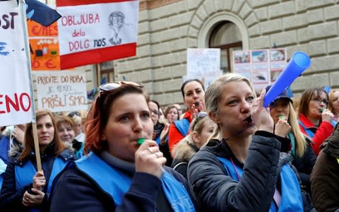 Protesters blow whistles during teachers' demonstration for higher wages in Ljubljana - Credit: Reuters
