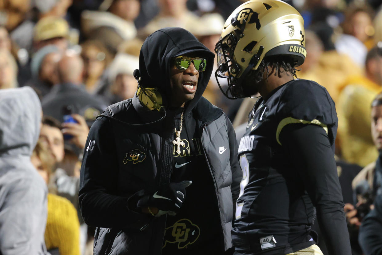 BOULDER, COLORADO - OCTOBER 13: Head coach Deion Sanders and Shedeur Sanders #2 of the Colorado Buffaloes talk before taking on the Stanford Cardinal at Folsom Field on October 13, 2023 in Boulder, Colorado. (Photo by Justin Tafoya/Getty Images)