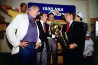 NBA Commissioner David Stern presents the championship trophy to Lakers owner Jerry Buss while the Los Angeles Lakers celebrate in the locker room after winning the 1985 NBA Finals against the Boston Celtics on June 9, 1985 in Boston, Massachusetts. Lakers 111 vs Celtics 100. (Photo by Andrew D. Bernstein/NBAE via Getty Images)