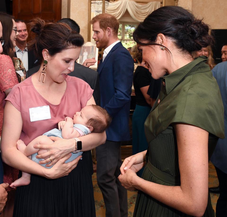 Meghan talks to Australian Singer Missy Higgins, with her 9 week old baby Lunar at the reception in Sydney (PA)