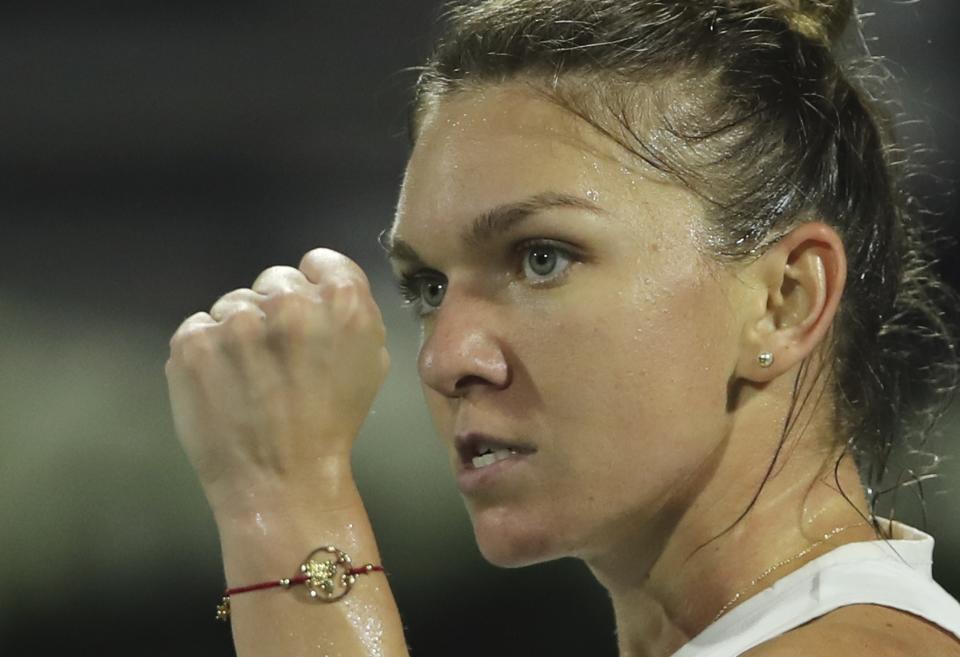 Romania's Simona Halep reacts after she got a point against Jennifer Brady of the U.S. during a semi final match of the Dubai Duty Free Tennis Championship in Dubai, United Arab Emirates, Friday, Feb. 21, 2020. (AP Photo/Kamran Jebreili)