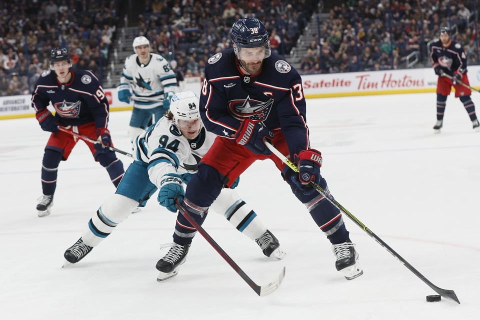 San Jose Sharks' Alexander Barabanov, left, chase Columbus Blue Jackets' Boone Jenner during the second period of an NHL hockey game on Saturday, Jan. 21, 2023, in Columbus, Ohio. (AP Photo/Jay LaPrete)