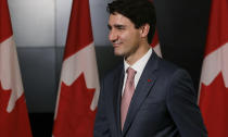 Canada's Prime Minister Justin Trudeau smiles after attending the APEC 2018 Economic Leaders Meeting at Port Moresby, Papua New Guinea on Sunday, Nov. 18, 2018. (AP Photo/Aaron Favila)