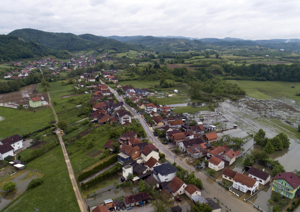 This aerial photo shows flooded neighborhood in Sanski Most, Bosnia-Herzegovina, Tuesday, May 14, 2019. Homes and roads have been flooded in parts of Bosnia after rivers broke their banks following heavy rains, triggering concerns Tuesday of a repeat of floods five years ago when dozens died. (AP Photo/Darko Bandic)